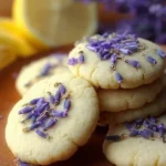 Plate of homemade Lemon Lavender Cookies with fresh lemon slices and lavender
