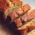 Freshly baked banana bread sliced and served with butter.