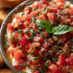 Vibrant bruschetta dip served with fresh bread for an appetizer