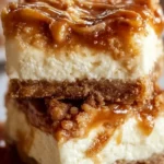 Delicious Caramel Apple Cheesecake Bars topped with caramel and apple slices.