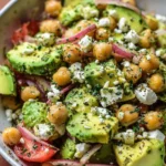 Chickpea Feta Avocado Salad with fresh vegetables and herbs in a bowl
