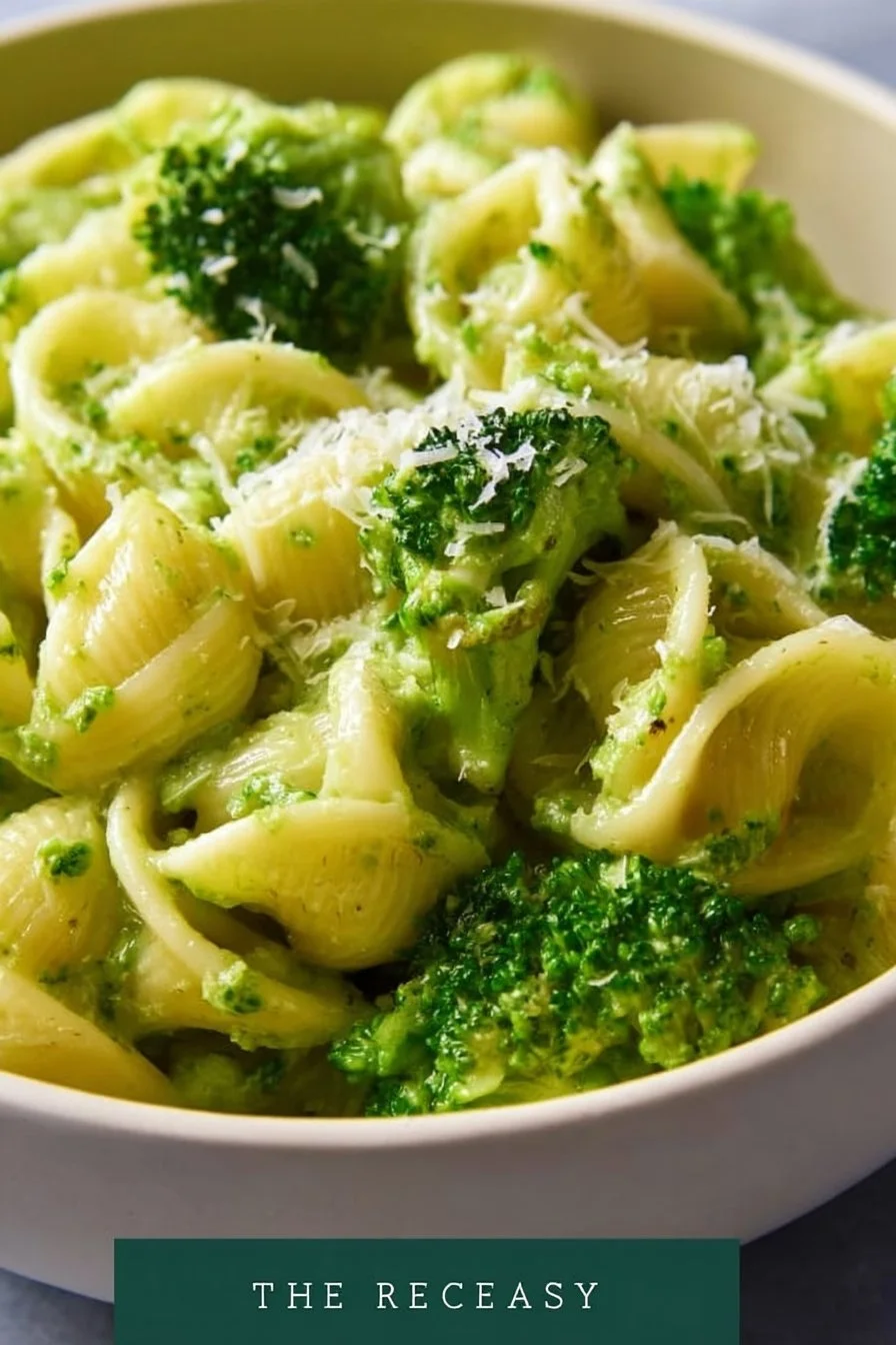 Bowl of easy healthy broccoli pasta topped with grated cheese and fresh herbs