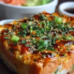 Delicious Spicy Salmon Sushi Bake served in a baking dish with garnishes.