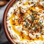 Delicious ricotta dip topped with hot honey, served with bread for dipping.