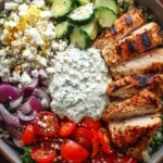 Delicious Greek Chicken Bowl with fresh vegetables and herbs